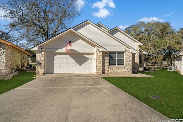 view of front facade featuring driveway, stone siding, a garage, and a front yard