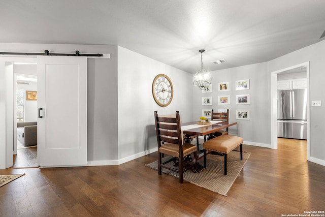 dining space with a barn door, visible vents, baseboards, dark wood-style floors, and a chandelier