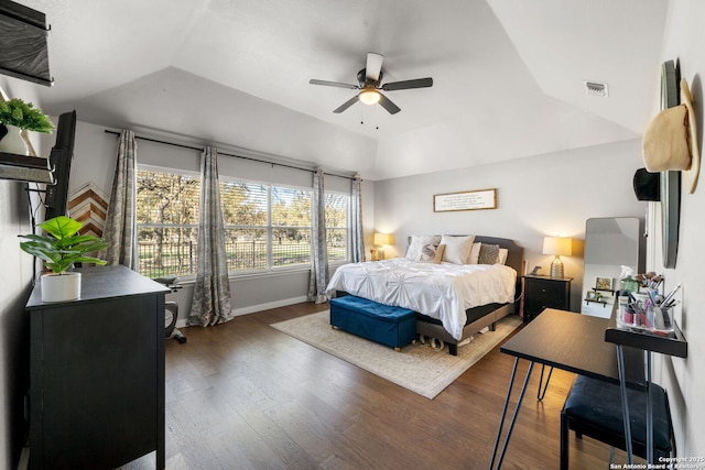 bedroom featuring baseboards, visible vents, a ceiling fan, wood finished floors, and vaulted ceiling