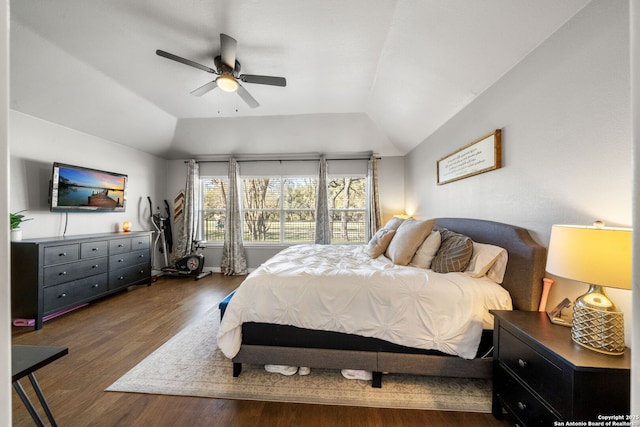 bedroom with a ceiling fan, vaulted ceiling, and wood finished floors