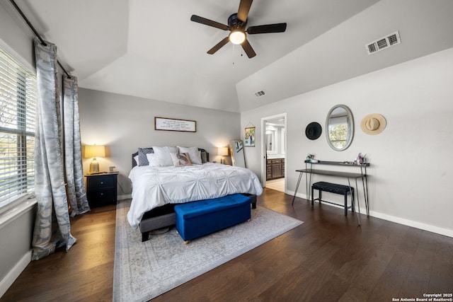 bedroom with lofted ceiling, baseboards, visible vents, and wood finished floors