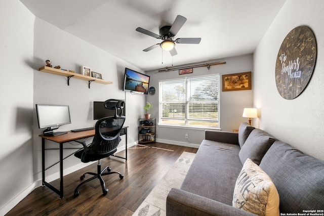 home office featuring a ceiling fan, baseboards, and wood finished floors