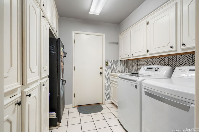 laundry room featuring cabinet space, washing machine and clothes dryer, and light tile patterned floors