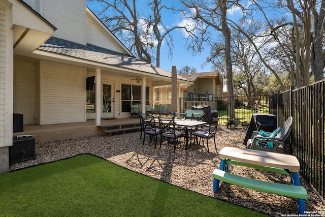 view of patio / terrace with ceiling fan and fence