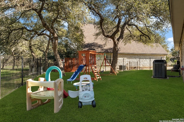 view of play area featuring a yard, cooling unit, and fence