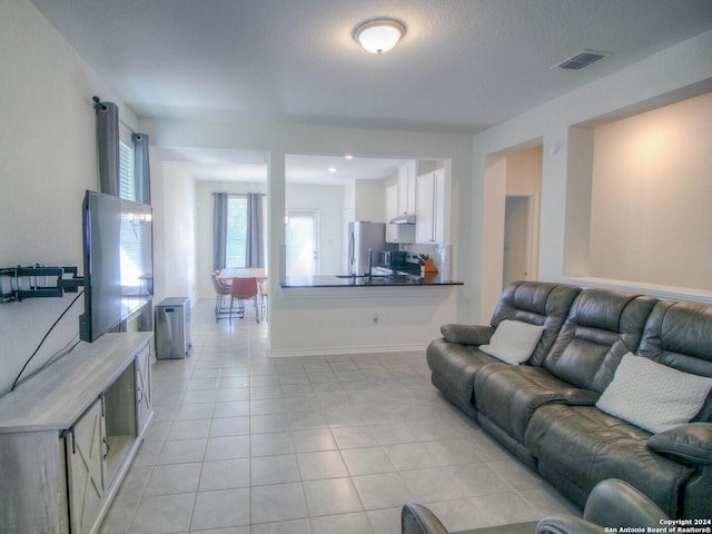 living room with visible vents and light tile patterned floors