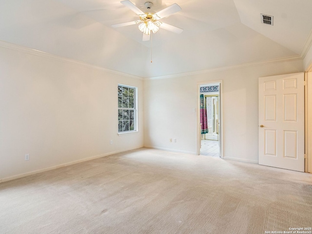 empty room featuring visible vents, a ceiling fan, light colored carpet, ornamental molding, and vaulted ceiling