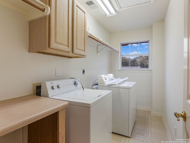 laundry room with cabinet space, baseboards, visible vents, independent washer and dryer, and light floors