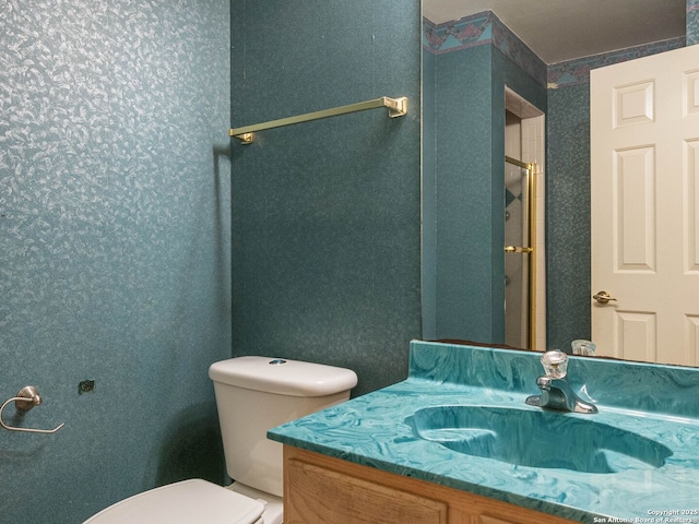 bathroom featuring toilet and vanity