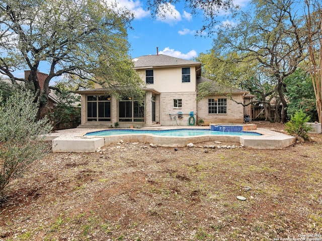 pool featuring a patio area and a sunroom