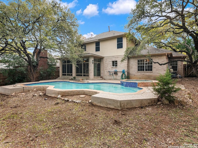 pool featuring a sunroom, a patio, and an in ground hot tub