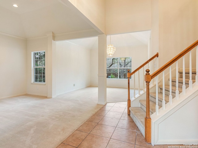 interior space with stairway, plenty of natural light, carpet flooring, and a notable chandelier