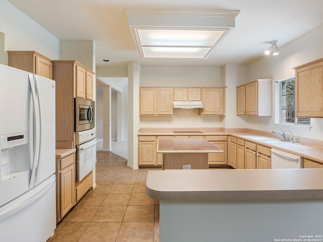 kitchen with white appliances and light brown cabinets