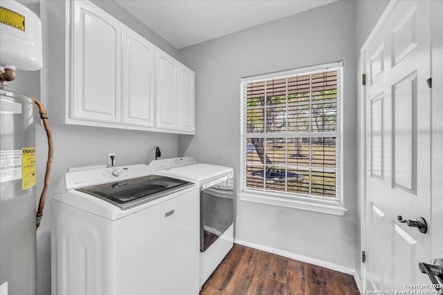 laundry area featuring cabinet space, baseboards, washer and clothes dryer, dark wood-style flooring, and water heater