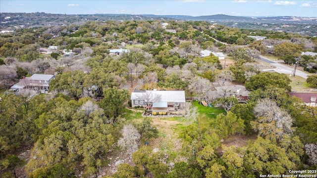 drone / aerial view featuring a wooded view