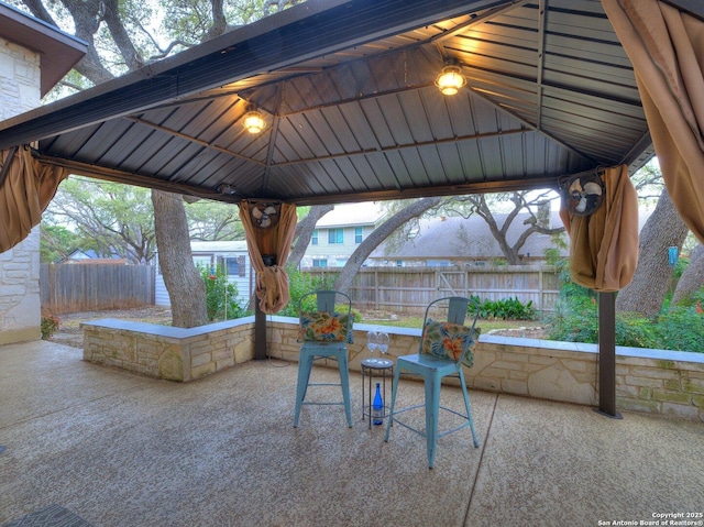 view of patio with fence and a gazebo