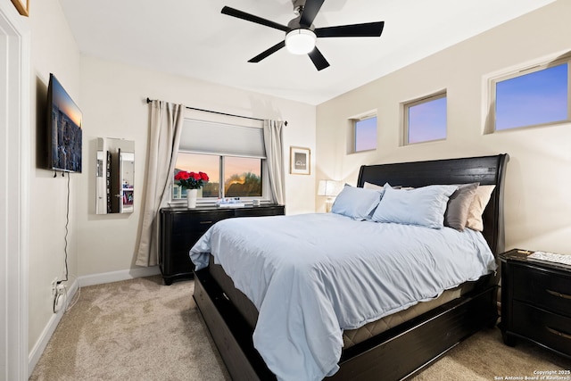 bedroom featuring light carpet, ceiling fan, and baseboards