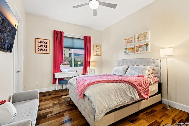 bedroom featuring ceiling fan, baseboards, and wood finished floors