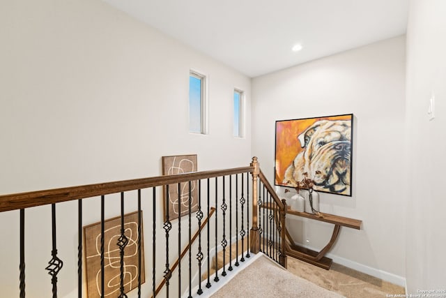 hallway with carpet floors, recessed lighting, an upstairs landing, and baseboards