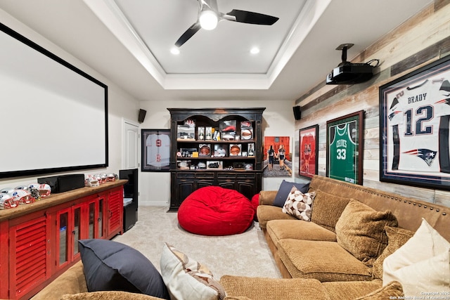 home theater room with recessed lighting, ceiling fan, a raised ceiling, and light colored carpet