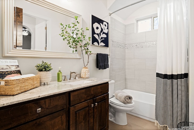 bathroom with toilet, shower / bath combination with curtain, and vanity