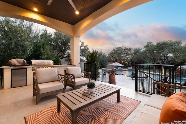 view of patio / terrace featuring ceiling fan, grilling area, area for grilling, and an outdoor living space