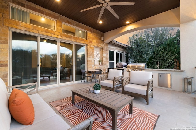 view of patio with an outdoor kitchen, ceiling fan, an outdoor hangout area, and area for grilling