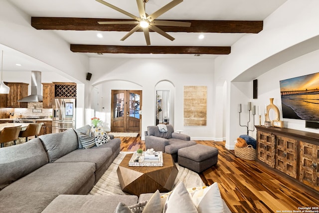 living area featuring arched walkways, french doors, wood finished floors, beamed ceiling, and baseboards