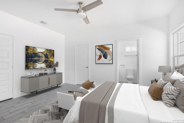 bedroom with visible vents, ceiling fan, connected bathroom, wood finished floors, and baseboards