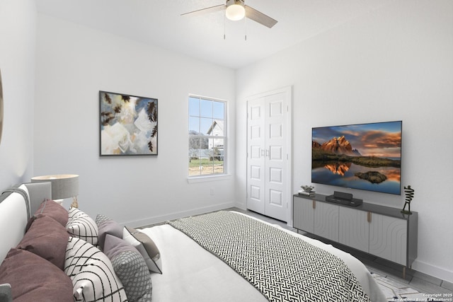 bedroom with a closet, a ceiling fan, and baseboards