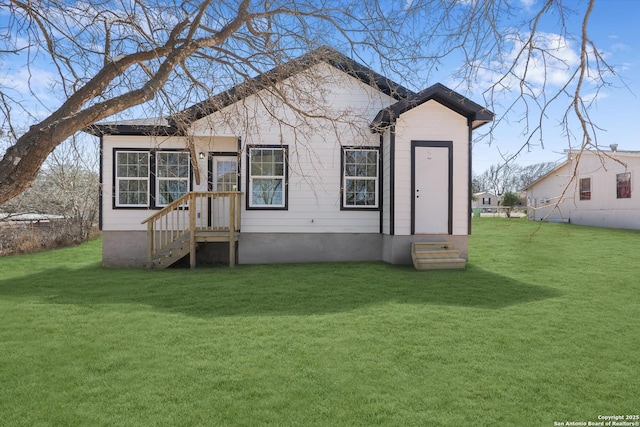 rear view of property with a yard