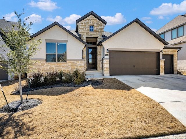 view of front of property featuring stone siding, concrete driveway, an attached garage, and stucco siding