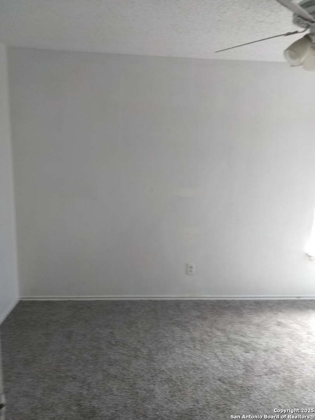 unfurnished room with carpet floors, ceiling fan, baseboards, and a textured ceiling