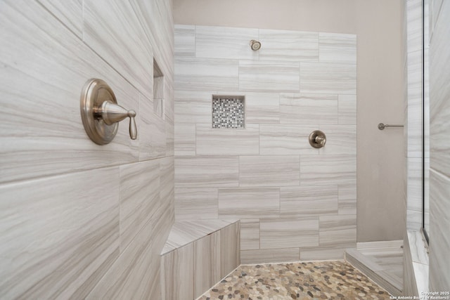 bathroom featuring tiled shower