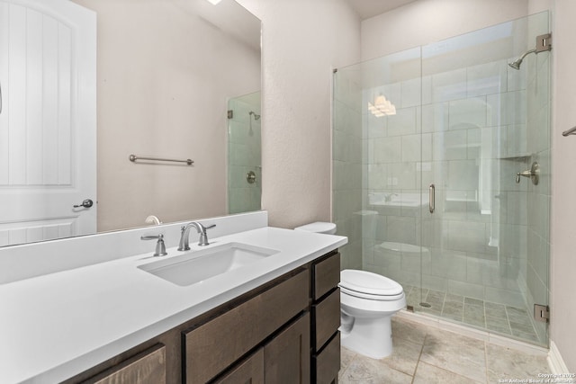 bathroom featuring toilet, a shower stall, and vanity