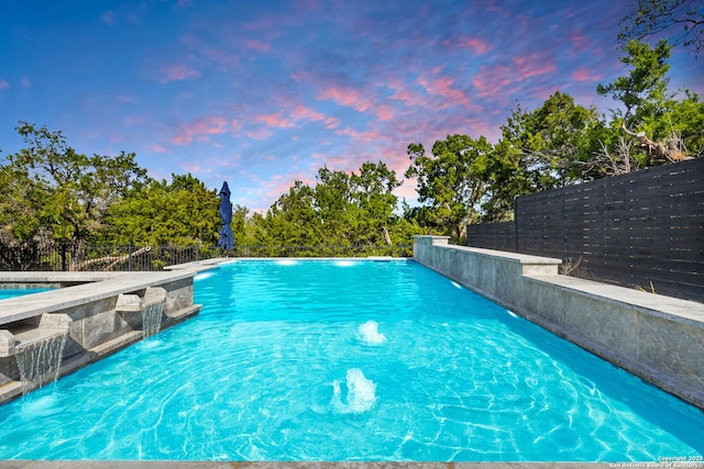 view of swimming pool with a fenced backyard and a fenced in pool