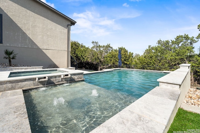 view of swimming pool with a fenced in pool and an in ground hot tub