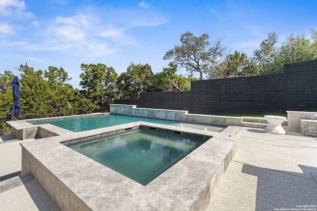 view of swimming pool with a fenced backyard, a fenced in pool, a patio, and an in ground hot tub