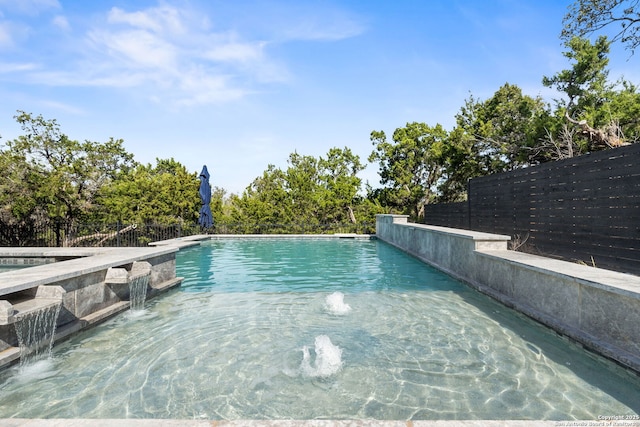 view of pool with a fenced in pool and fence