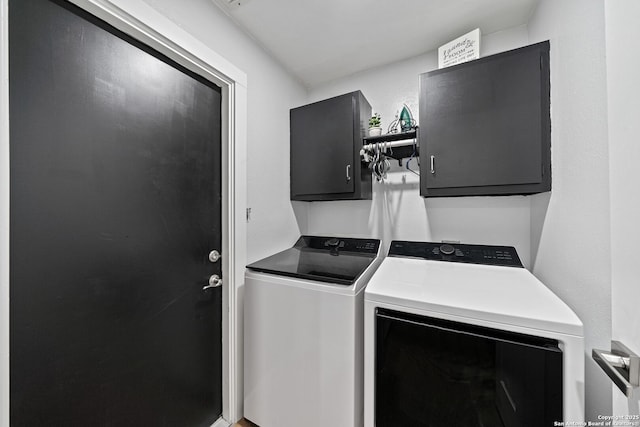 laundry area featuring separate washer and dryer and cabinet space