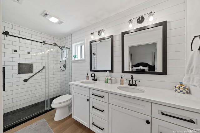 bathroom with a sink, visible vents, and a shower stall