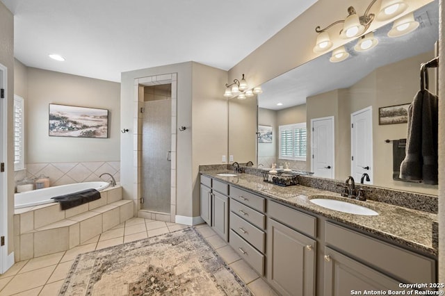 bathroom featuring a sink, a shower stall, a bath, and tile patterned floors