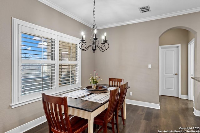 dining area featuring dark wood-style floors, baseboards, visible vents, and arched walkways