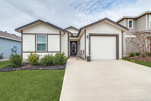 ranch-style home featuring an attached garage, a front lawn, and concrete driveway