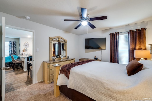 bedroom featuring light carpet and ceiling fan