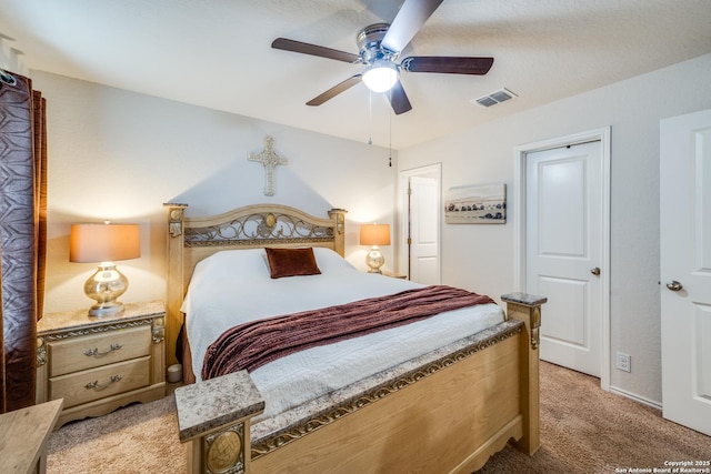 bedroom featuring light carpet, ceiling fan, and visible vents