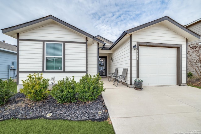 ranch-style house with a garage and concrete driveway