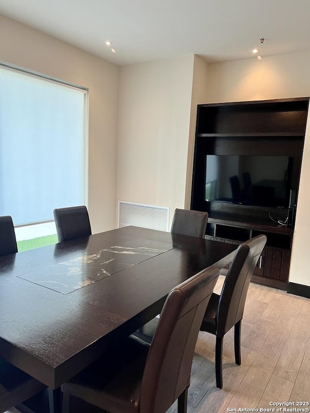 dining room featuring light wood-type flooring, visible vents, and recessed lighting