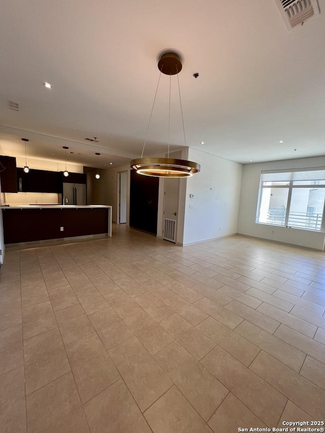 unfurnished living room with recessed lighting, visible vents, baseboards, and light tile patterned floors