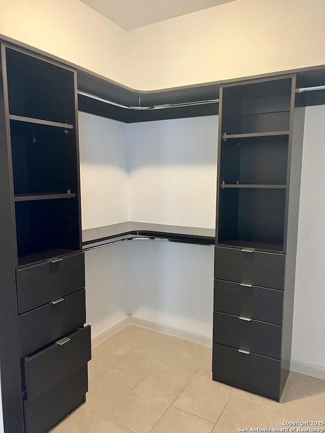 spacious closet featuring light tile patterned floors